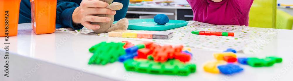 Teacher working with a child on occupational therapy